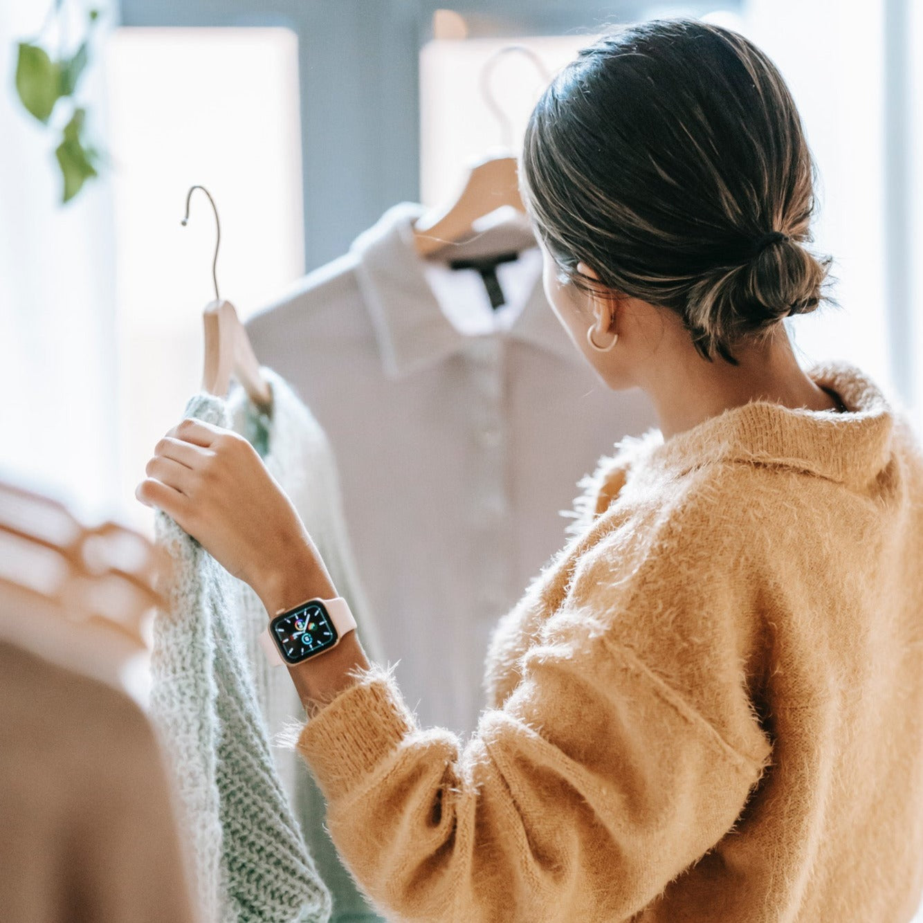 Woman looking at clothing options.