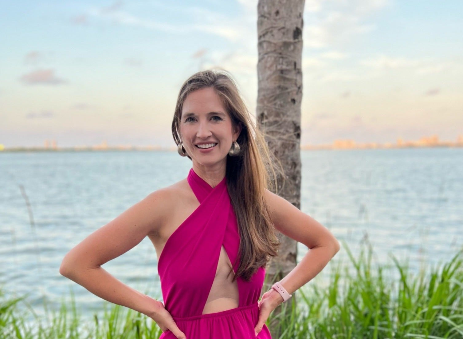 Woman wearing a pink dress for a summer wedding.